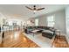 Bright and open living room featuring hardwood floors, ceiling fan and grey sectional sofa at 2915 Wesley Ave, Charlotte, NC 28205
