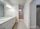Bathroom with dual sink vanity, tile floors, and a walk-in shower featuring tiled walls and niche at 3069 Founding Fathers Dr, Gastonia, NC 28056
