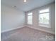 Cozy bedroom features neutral walls, plush carpet, and two windows that offer plenty of natural light at 3069 Founding Fathers Dr, Gastonia, NC 28056