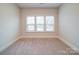 Spacious, carpeted bedroom featuring three windows providing natural light and neutral wall color at 3069 Founding Fathers Dr, Gastonia, NC 28056