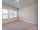 Bedroom boasts neutral carpet and walls with a three-window combination, creating a bright atmosphere at 3069 Founding Fathers Dr, Gastonia, NC 28056