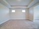 Expansive bonus room with carpeting, tray ceiling, and plenty of natural light from multiple windows at 3069 Founding Fathers Dr, Gastonia, NC 28056