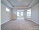 Large bonus room with plush carpet and tray ceiling, ideal for entertainment or relaxation at 3069 Founding Fathers Dr, Gastonia, NC 28056