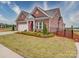 Well-manicured lawn frames this brick home with an attached two car garage and a black metal fence at 3069 Founding Fathers Dr, Gastonia, NC 28056