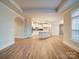 Open concept kitchen with stainless appliances, island, tile backsplash, and wood flooring at 3069 Founding Fathers Dr, Gastonia, NC 28056