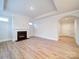 Light-filled living room with wood-look floors, a fireplace, and modern trim at 3069 Founding Fathers Dr, Gastonia, NC 28056