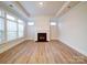 Living room featuring fireplace, large windows, and wood-look flooring at 3069 Founding Fathers Dr, Gastonia, NC 28056