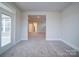 Comfortable living room with neutral walls, plush carpet, and a doorway that leads to another room at 3069 Founding Fathers Dr, Gastonia, NC 28056