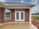 Covered patio featuring a brick exterior, concrete floors, and white columns at 3069 Founding Fathers Dr, Gastonia, NC 28056