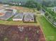 An aerial view shows a brick home with a covered patio and meticulously landscaped yard in a well-planned community at 3089 Founding Fathers Dr, Gastonia, NC 28056