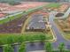 Aerial shot shows a home and manicured landscaping bordering new construction in a developing neighborhood at 3089 Founding Fathers Dr, Gastonia, NC 28056