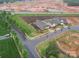 An aerial view of a home with manicured landscaping and view of ongoing construction in a vibrant new neighborhood at 3089 Founding Fathers Dr, Gastonia, NC 28056