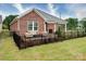 Aerial view of a backyard featuring a brick home, patio, seating area, well-maintained lawn, and black metal fence at 3089 Founding Fathers Dr, Gastonia, NC 28056