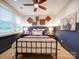 Cozy bedroom featuring rustic decor, ample natural light, and a ceiling fan at 3089 Founding Fathers Dr, Gastonia, NC 28056