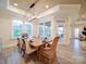 The bright dining room features a modern lighting fixture, wood floors, and natural light from many windows at 3089 Founding Fathers Dr, Gastonia, NC 28056