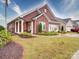Beautiful brick home with a covered porch, American flag, and well-maintained lawn at 3089 Founding Fathers Dr, Gastonia, NC 28056