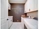 A dedicated laundry room features modern appliances and ample cabinet storage space at 3089 Founding Fathers Dr, Gastonia, NC 28056