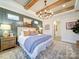A gorgeous main bedroom showcases ceiling beams, a chandelier, and attractive decor at 3089 Founding Fathers Dr, Gastonia, NC 28056