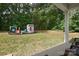 Backyard view featuring a playhouse and swingset situated on a well-maintained grassy area at 325 Cornwall Dr, Salisbury, NC 28147