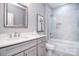 Elegant bathroom with a large vanity, framed mirror, and glass-enclosed shower-over-tub at 325 Cornwall Dr, Salisbury, NC 28147
