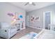 Bright bedroom with colorful decor, cozy seating, and wood-look flooring at 325 Cornwall Dr, Salisbury, NC 28147