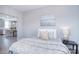 Bright bedroom featuring soft grey tones, modern decor, and views into the kitchen and living area at 325 Cornwall Dr, Salisbury, NC 28147