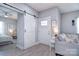 Bright entryway with a gray sofa, barn door, and wood-look flooring at 325 Cornwall Dr, Salisbury, NC 28147