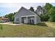 An inviting single-story house featuring gray siding, a covered porch, and a verdant, expansive lawn at 325 Cornwall Dr, Salisbury, NC 28147