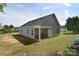 View of the exterior showcasing the back porch, vinyl siding, and well-maintained lawn at 325 Cornwall Dr, Salisbury, NC 28147