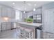 Bright kitchen with gray cabinets, stainless steel appliances, and a large island with bar stool seating at 325 Cornwall Dr, Salisbury, NC 28147