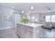 Open kitchen area with a central island, pendant lighting, and a glimpse into the adjacent living room at 325 Cornwall Dr, Salisbury, NC 28147