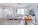 Cozy living room with a gray sectional sofa, ceiling fan, and natural light from the window at 325 Cornwall Dr, Salisbury, NC 28147