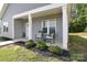 Inviting front porch area with gray siding, black mulch, and outdoor seating at 325 Cornwall Dr, Salisbury, NC 28147