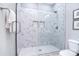 Modern shower with white marble-style tile, frameless glass door, and dual inset storage shelves at 325 Cornwall Dr, Salisbury, NC 28147