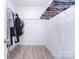 Bright walk-in closet with laminate flooring and chrome rod and shelving storage at 325 Cornwall Dr, Salisbury, NC 28147