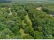 Aerial shot of wooded acreage offering privacy, with a cleared grassy area providing space at 3387 Passmore Rd, Rock Hill, SC 29730