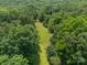 Aerial view showcasing large grassy area surrounded by lush trees at 3387 Passmore Rd, Rock Hill, SC 29730