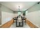 Formal dining room with white wainscoting, contemporary lighting, and hardwood floors at 3387 Passmore Rd, Rock Hill, SC 29730