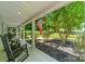 Charming front porch with rocking chairs, an American flag, and a well-maintained yard at 3387 Passmore Rd, Rock Hill, SC 29730