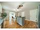 Bright kitchen featuring an island with granite countertops, wood floors, and stylish light fixtures at 3387 Passmore Rd, Rock Hill, SC 29730