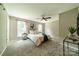Spacious main bedroom with neutral colors, carpet flooring, ceiling fan, and large windows at 3387 Passmore Rd, Rock Hill, SC 29730