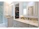 Well-lit bathroom with dual vanities, granite countertops, and a walk-in closet at 3670 9Th Street Ne Dr # 96, Hickory, NC 28601