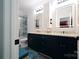 Modern bathroom featuring dual sinks, dark blue cabinetry, and a glass-enclosed shower at 3670 9Th Street Ne Dr # 96, Hickory, NC 28601