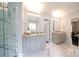 Bright bathroom featuring marble floors, double vanities, and a glass-enclosed shower with marble tiling at 3670 9Th Street Ne Dr # 96, Hickory, NC 28601