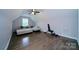 Large bonus room featuring hardwood floors, a ceiling fan, and ample seating and exercise equipment at 3670 9Th Street Ne Dr # 96, Hickory, NC 28601