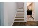 Staircase with wood treads and white risers leading up to a landing near the laundry room at 3670 9Th Street Ne Dr # 96, Hickory, NC 28601