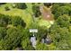 Scenic aerial view of property with golf course and pond, nestled among lush greenery at 3932 Rounding Run Rd, Charlotte, NC 28277