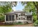 Rear exterior of home showcasing screened in porches and backyard deck areas at 3932 Rounding Run Rd, Charlotte, NC 28277