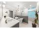 Bright bathroom features a soaking tub, standalone shower, and dual sink vanity with marble countertop at 3932 Rounding Run Rd, Charlotte, NC 28277