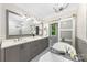 Bright bathroom features a soaking tub, standalone shower, and dual sink vanity with marble countertop at 3932 Rounding Run Rd, Charlotte, NC 28277